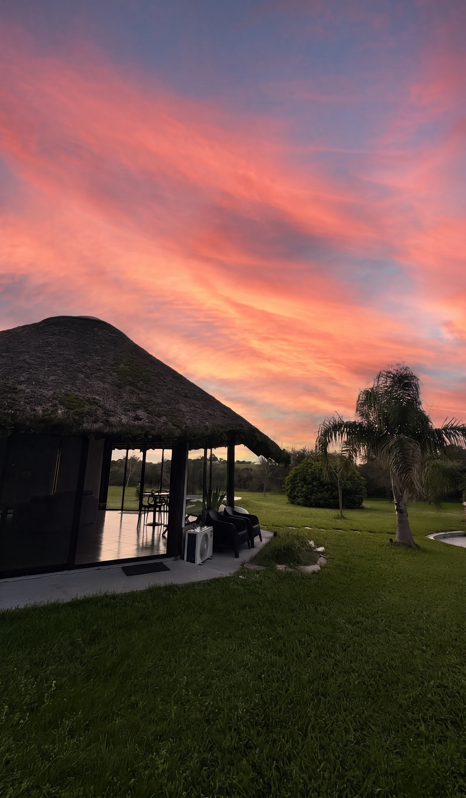 Atardecer sobre el espacio con techo de paja donde se realiza Becoming Club, en Paysandú